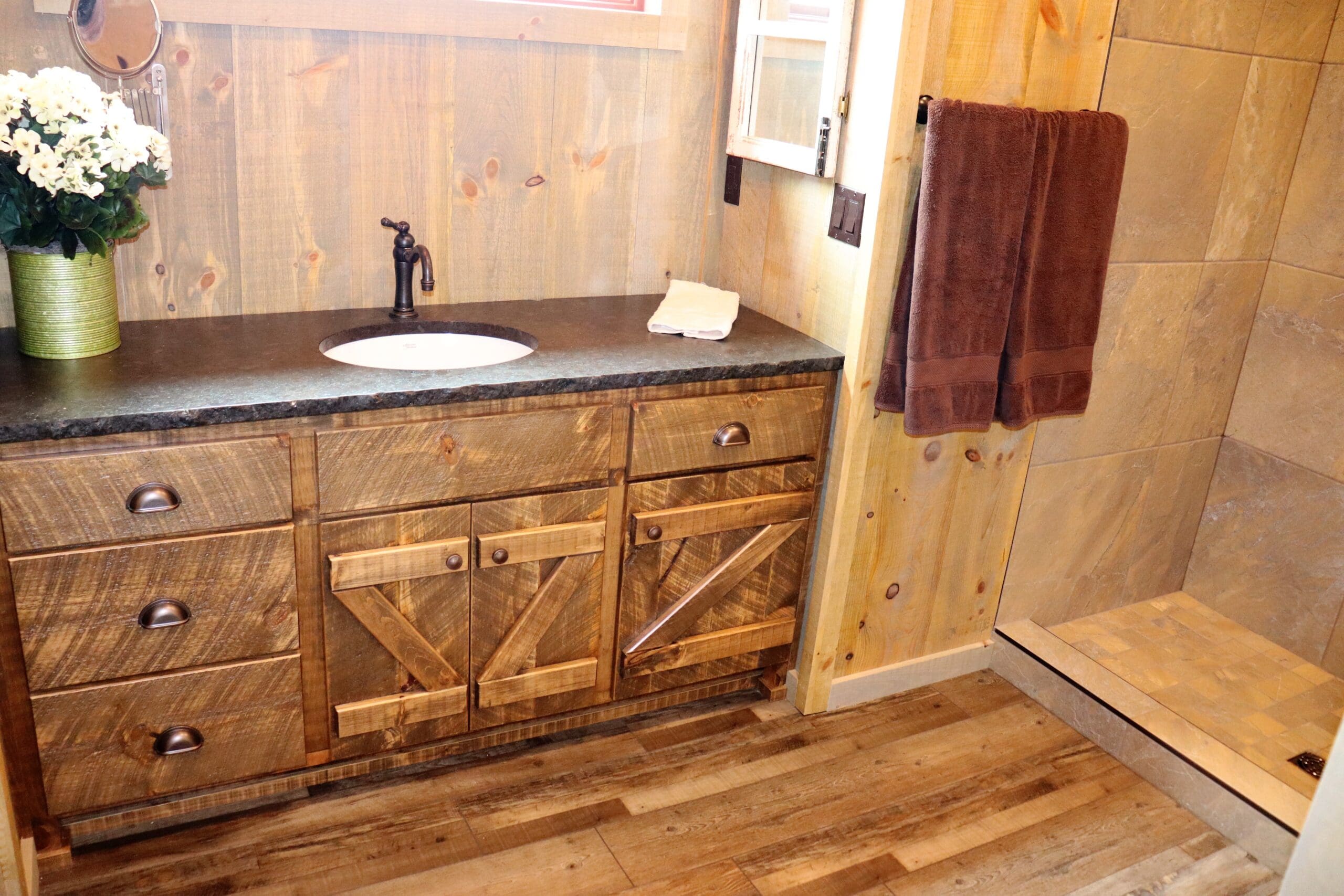Bathroom with wood cabinet and tiled shower